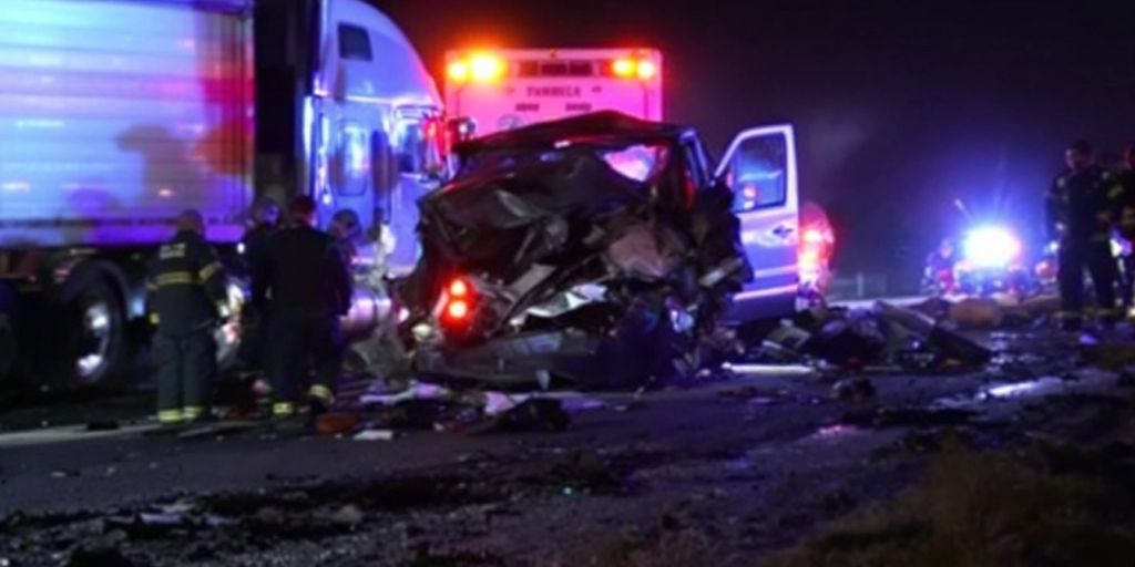 Mangled car and semi-truck after a tragic collision.