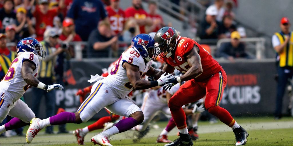 Chiefs and Buccaneers players during an intense football game.