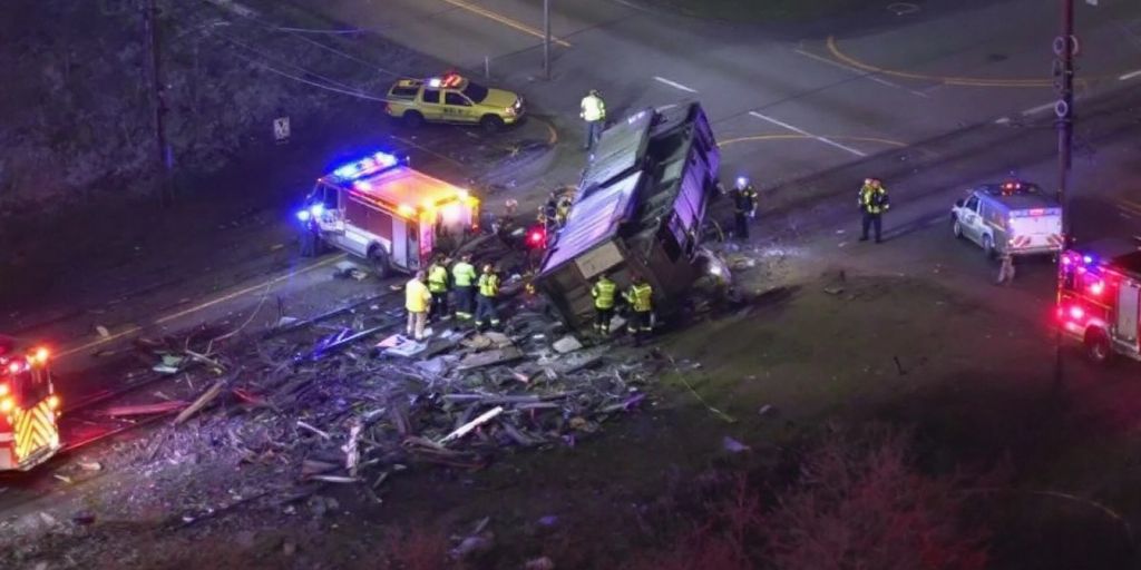 Rail car accident scene with emergency responders on site.